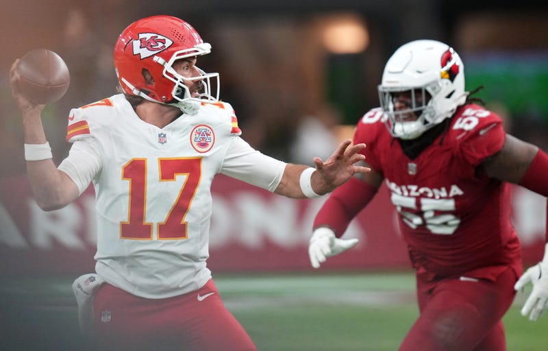 Kansas City Chiefs quarterback Gardner Minshew (17) looks to throw the ball as Arizona Cardinals defensive lineman Dante Stills (55) closes in during their preseason game at State Farm Stadium on Aug. 9, 2025.