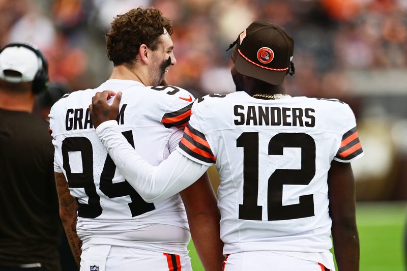 Aug 23, 2025; Cleveland, Ohio, USA; Cleveland Browns defensive tackle Mason Graham (94) and quarterback Shedeur Sanders (12) talk on the sidelines during the first half against the Los Angeles Rams at Huntington Bank Field.