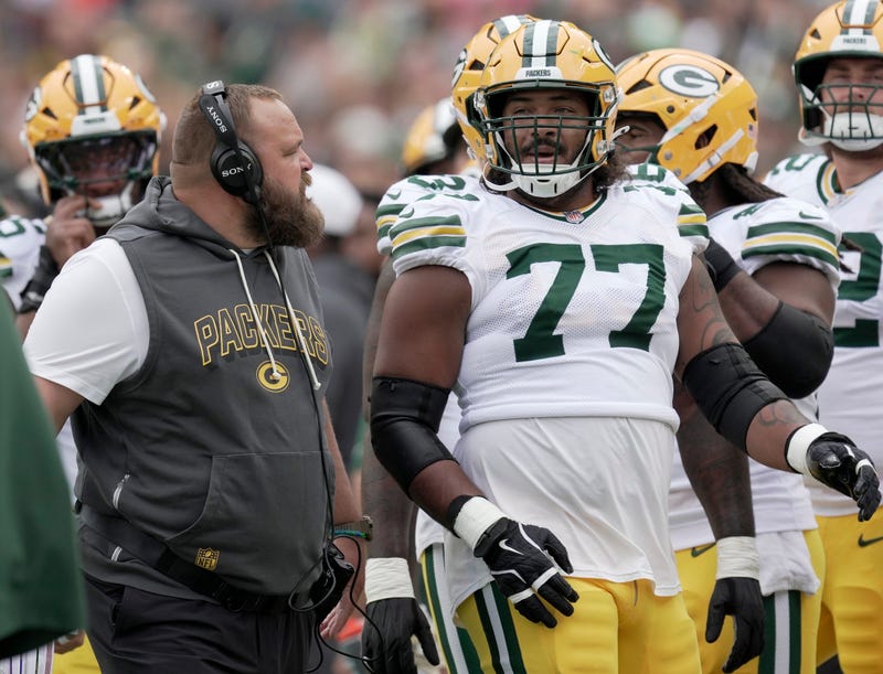 Green Bay Packers offensive tackle Jordan Morgan (77) listens to offensive line coach Luke Butkus during the first quarter of their preseason game Saturday, August 23, 2025 at Lambeau Field in Green Bay, Wisconsin. The Green Bay Packers beat the Seattle Seahawks 20-7.