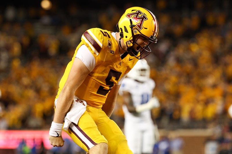 Minnesota Golden Gophers quarterback Drake Lindsey (5) celebrates wide receiver Jalen Smith's (8) touchdown against the Buffalo Bulls during the second half of the game at Huntington Bank Stadium.