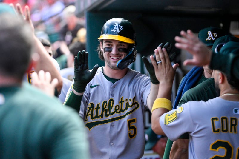 Athletics shortstop Jacob Wilson (5) is congratulated by teammates after scoring against the St. Louis Cardinals during the seventh inning at Busch Stadium.