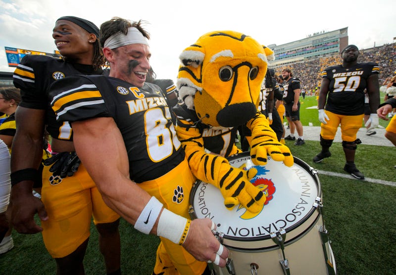 Missouri Tigers wide receiver Logan Muckey (82) celebrates with mascot Truman the Tiger after defeating the Kansas Jayhawks at Faurot Field at Memorial Stadium.