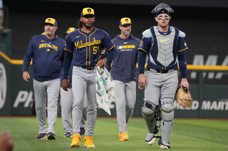 Sep 10, 2025; Arlington, Texas, USA; Milwaukee Brewers starting pitcher Freddy Peralta (51) and catcher Danny Jansen (33) walk to the dugout before the first inning against the Texas Rangers at Globe Life Field. Mandatory Credit: Jim Cowsert-Imagn Images