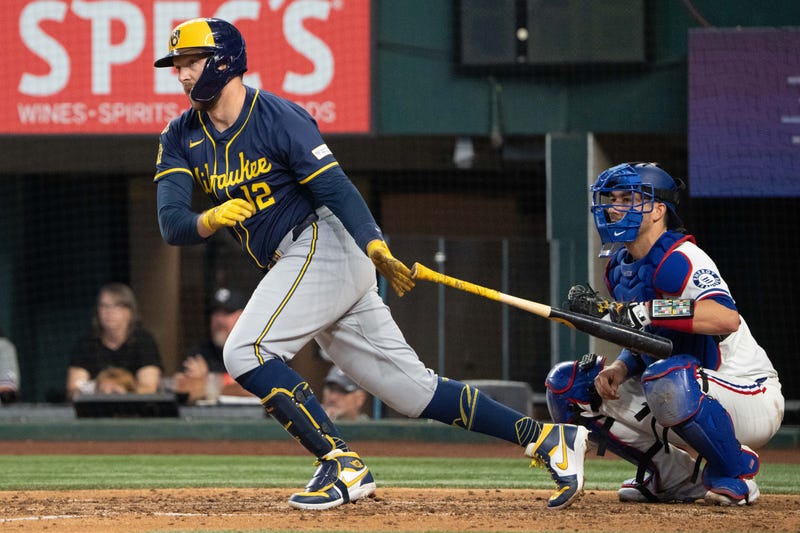 Sep 10, 2025; Arlington, Texas, USA; Milwaukee Brewers first baseman Rhys Hoskins (12) follows through on his RBI single against the Texas Rangers during the sixth inning at Globe Life Field. Mandatory Credit: Jim Cowsert-Imagn Images1