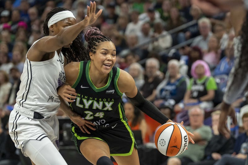 Minnesota Lynx forward Napheesa Collier (24) dribbles the ball past Golden State Valkyries guard Kaila Charles (6) in the first half during game one of round one for the 2025 WNBA Playoffs at Target Center.