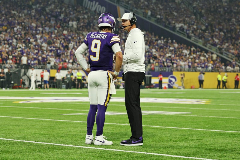 Minnesota Vikings quarterback J.J. McCarthy (9) speaks with Minnesota Vikings head coach Kevin O'Connell during the first half against the Atlanta Falcons at U.S. Bank Stadium.