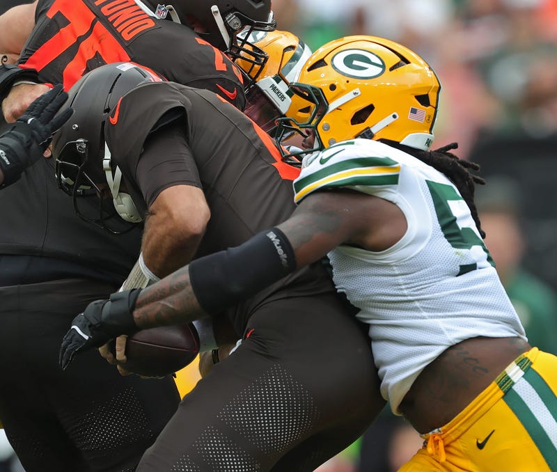 Cleveland Browns quarterback Joe Flacco (15) is sacked by Green Bay Packers defensive end Rashan Gary (52) during the second half of an NFL football game at Huntington Bank Field, Sept. 21, 2025, in Cleveland, Ohio.