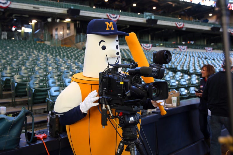 Barrel Man, one of the Brewers mascots operates a TV camera before the Milwaukee Brewers faced the Colorado Rockies for the home opener at Miller Park in Milwaukee, April 6, 2015. Barrel Man was originally the Brewers logo from 1970-1977. He became an official mascot in 2015.