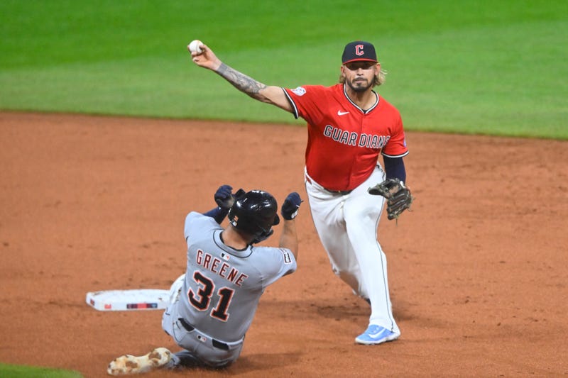 Guardians shortstop Gabriel Arias (13) turns a double play beside Detroit Tigers left fielder Riley Greene (31) in the second inning at Progressive Field