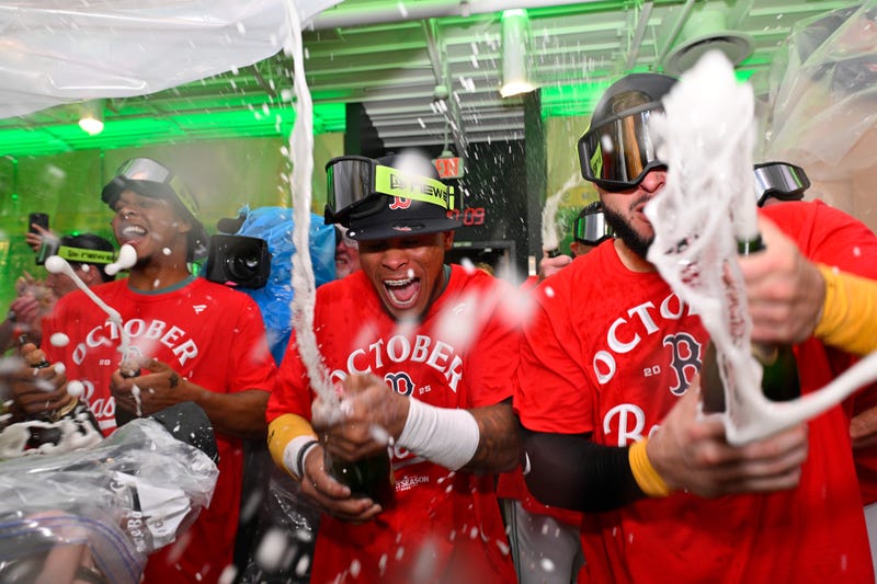 Boston, Massachusetts, USA; Boston Red Sox center fielder Ceddanne Rafaela (center) celebrates clinching a playoff spot with teammates after their game against the Detroit Tigers at Fenway Park.