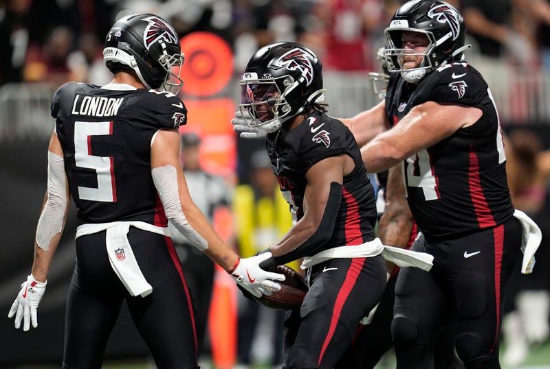 Atlanta Falcons running back Bijan Robinson (7) celebrates with wide receiver Drake London (5) after scoring a touchdown during the first half against the Washington Commanders at Mercedes-Benz Stadium
