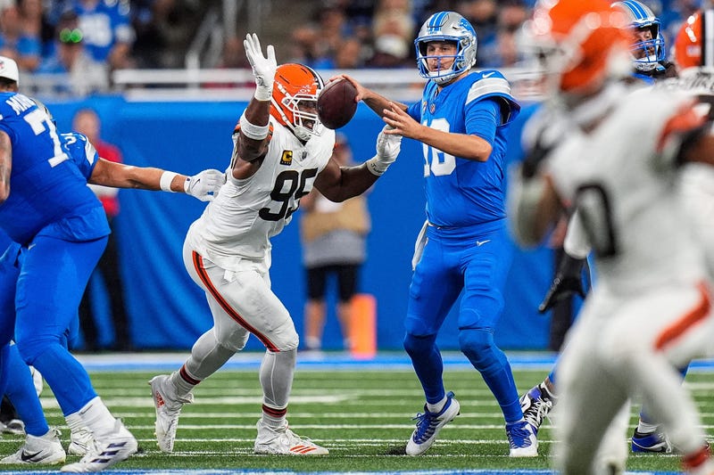 Detroit Lions quarterback Jared Goff (16) looks to pass as Cleveland Browns defensive end Myles Garrett (95) pressures him during the second half at Ford Field in Detroit on Sunday, Sept. 28, 2025.