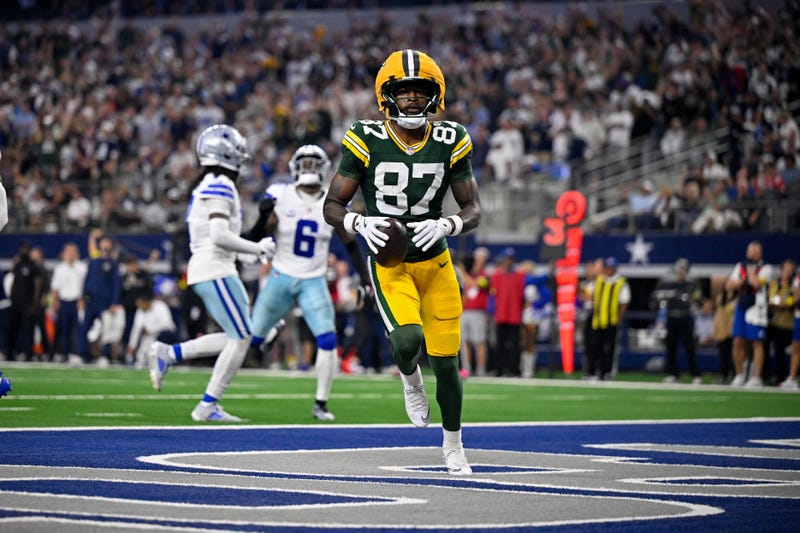Sep 28, 2025; Arlington, Texas, USA; Green Bay Packers wide receiver Romeo Doubs (87) celebrates in the end zone after he catches a pass for a touchdown during the game between the Dallas Cowboys and the Green Bay Packers at AT&T Stadium. Mandatory Credit: Jerome Miron-Imagn Images