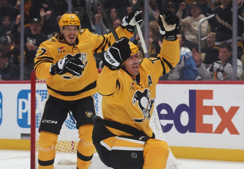 Evgeni Malkin celebrates scoring goal with Rickard Rakell in back