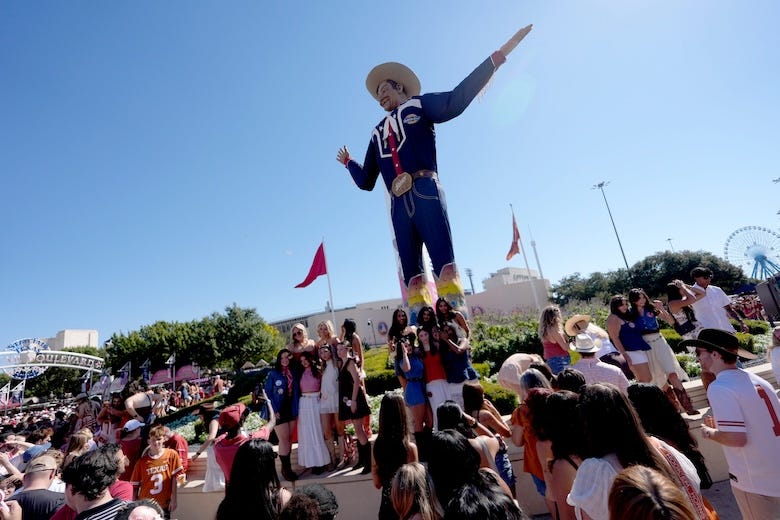 Visitors to the State Fair of Texas take pictures with Big Tex