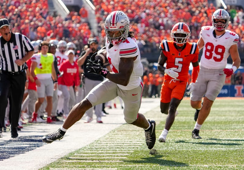 Ohio State Buckeyes wide receiver Jeremiah Smith (4) makes a catch during the NCAA football game against the Illinois Fighting Illini at Gies Memorial Stadium in Champaign on Oct. 11, 2025. Ohio State won 34-16.