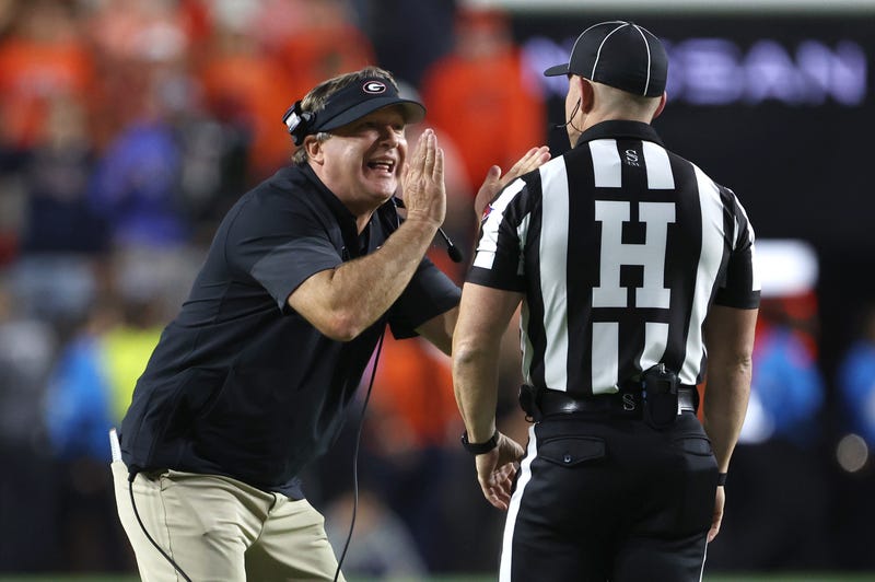 Oct 11, 2025; Auburn, Alabama, USA; Georgia Bulldogs head coach Kirby Smart tries to tell an official that he did not call a time out during the fourth quarter against the Auburn Tigers at Jordan-Hare Stadium.