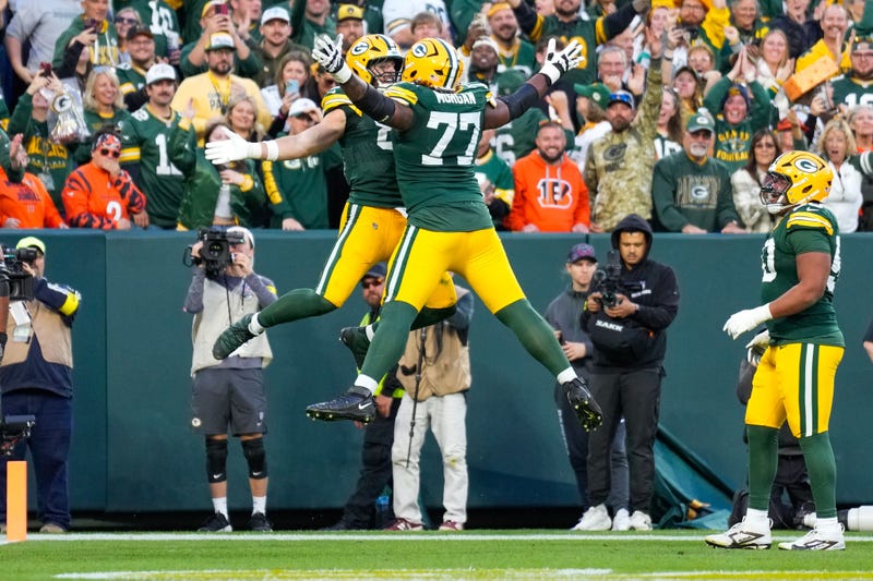 Oct 12, 2025; Green Bay, Wisconsin, USA; Green Bay Packers tight end Tucker Kraft (85) celebrates with tackle Jordan Morgan (77) after scoring a touchdown in the fourth quarter at Lambeau Field. Mandatory Credit: Jeff Hanisch-Imagn Images