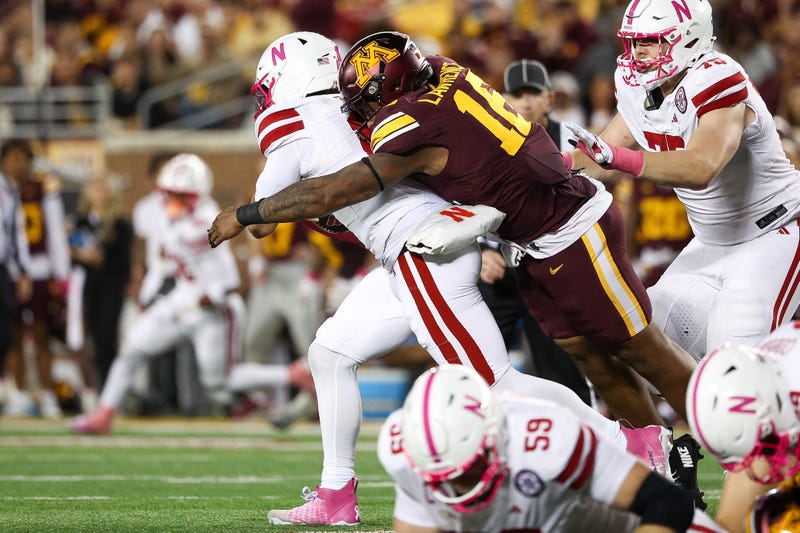 Minnesota Golden Gophers defensive lineman Rushawn Lawrence (16) tackles Nebraska Cornhuskers quarterback Dylan Raiola (15) during the second half at Huntington Bank Stadium.