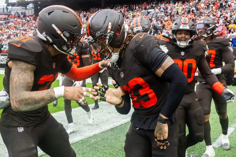 Cleveland Browns safety Ronnie Hickman Jr. (33) celebrates with safety Donovan McMillon (31) after an interception during the second half against the Miami Dolphins at Huntington Bank Field.