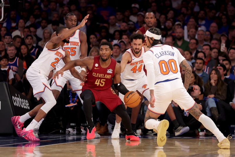 Oct 22, 2025; New York, New York, USA; Cleveland Cavaliers guard Donovan Mitchell (45) looks to pass the ball against New York Knicks guard Mikal Bridges (25) and center Ariel Hukporti (55) and guards Landry Shamet (44) and Jordan Clarkson (00) during the fourth quarter at Madison Square Garden.
