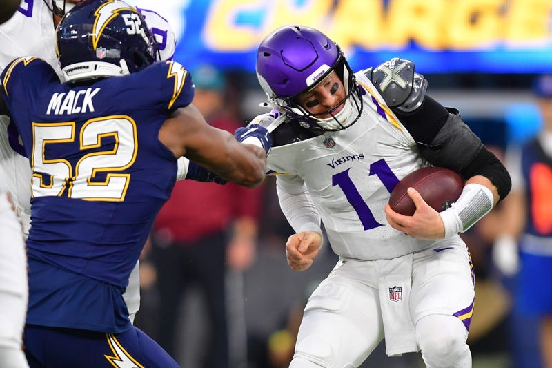The start of a long time for Carson Wentz and the Vikings as Chargers linebacker Khalil Mack (52) tackles the quarterback during the first half at SoFi Stadium.
