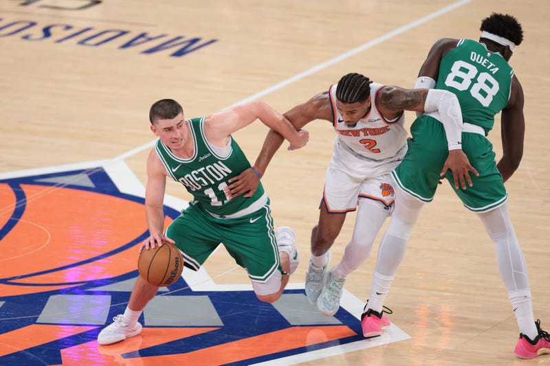 Boston Celtics guard Payton Pritchard (11) dribbles past New York Knicks guard Miles McBride (2) while center Neemias Queta (88) screens during the fourth quarter at Madison Square Garden.
