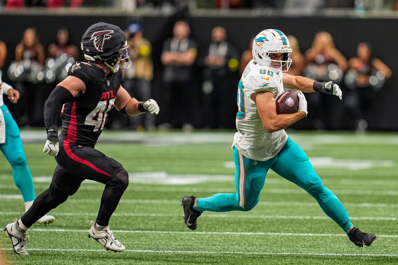 Miami Dolphins tight end Tanner Conner (80) runs against Atlanta Falcons linebacker JD Bertrand (40) during the second half at Mercedes-Benz Stadium.