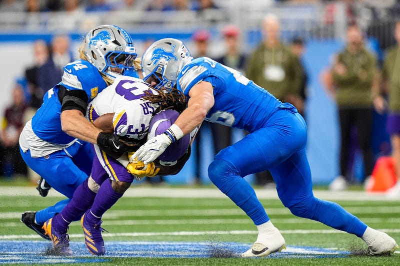 Detroit Lions linebacker Alex Anzalone (34) and linebacker Jack Campbell (46) tackle Minnesota Vikings running back Aaron Jones Sr. (33) during the first half at Ford Field in Detroit on Sunday, November 2, 2025. Jones left the game with a shoulder injury.