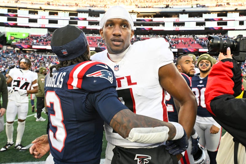 Atlanta Falcons quarterback Michael Penix Jr. (9) and New England Patriots wide receiver DeMario Douglas (3) hug after the game after the game at Gillette Stadium. 