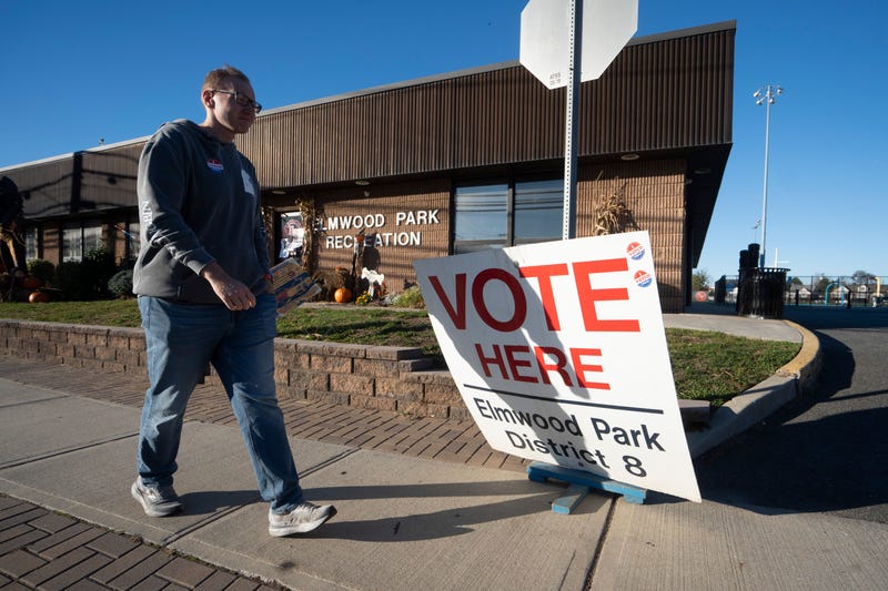 A voter walks past a voting sign at a polling location in the Elmwood Park Recreation Building in Bergen County on Tuesday, Nov. 4, 2025