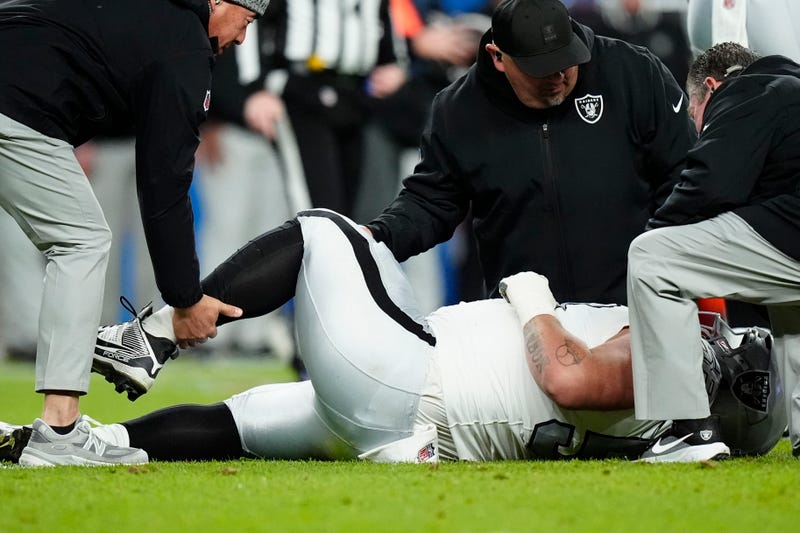 Las Vegas Raiders guard Jackson Powers-Johnson (58) is rendered aid from the training staff against the Denver Broncos during the first half at Empower Field at Mile High.