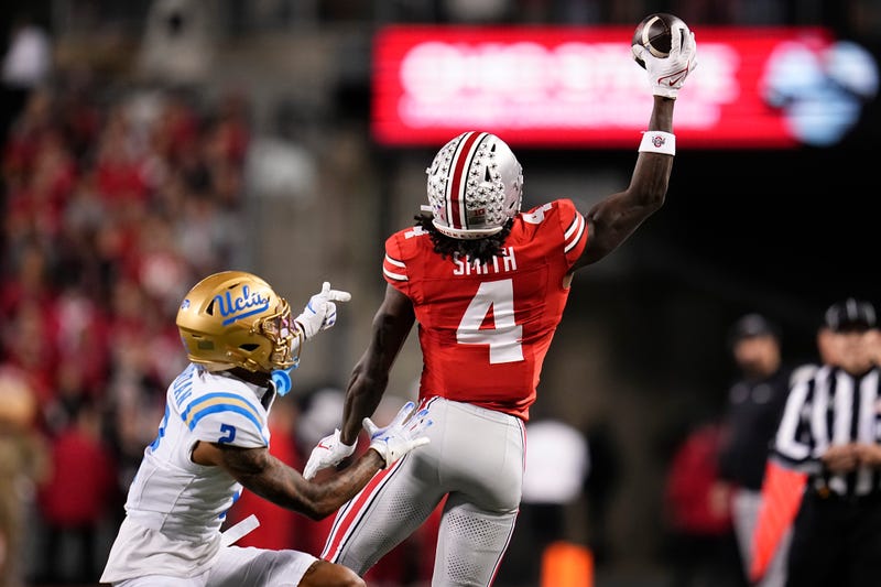 Ohio State Buckeyes wide receiver Jeremiah Smith (4) makes a one-handed catch in front of UCLA Bruins defensive back Andre Jordan Jr. (2) during the NCAA football game at Ohio Stadium in Columbus on Nov. 15, 2025. © Adam Cairns/Columbus Dispatch / USA TODAY NETWORK via Imagn Images