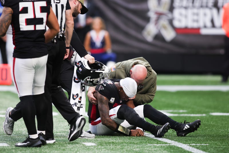 Atlanta Falcons quarterback Michael Penix Jr. (9) is attended to by medical staff in the third quarter against the Carolina Panthers at Mercedes-Benz Stadium.