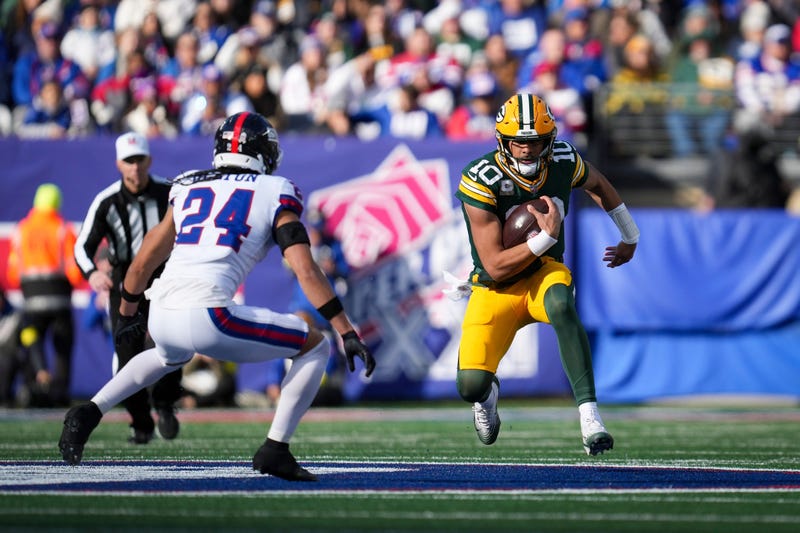 Green Bay Packers quarterback Jordan Love (10) runs the ball as New York Giants safety Dane Belton (24) defends during a game at MetLife Stadium, Nov 16, 2025, East Rutherford, NJ, USA.