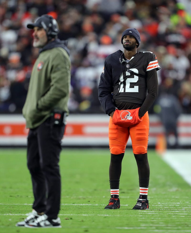 Cleveland Browns quarterback Shedeur Sanders (12) waits for his opportunity as head coach Kevin Stefanski watches Dillon Gabriel lead the offense during the first half of an NFL football game at Huntington Bank Field, Nov. 16, 2025, in Cleveland, Ohio.
