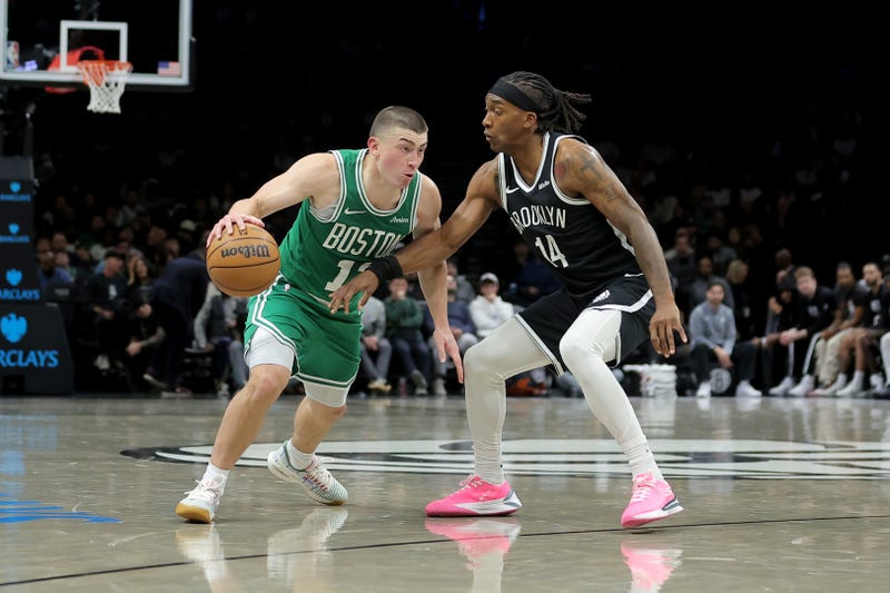 Boston Celtics guard Payton Pritchard (11) controls the ball against Brooklyn Nets guard Terance Mann (14) during the second quarter at Barclays Center.