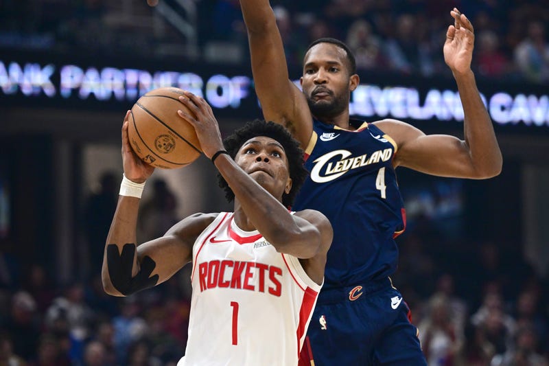 Nov 19, 2025; Cleveland, Ohio, USA; Houston Rockets guard Amen Thompson (1) goes to the basket against Cleveland Cavaliers center Evan Mobley (4) during the first half at Rocket Arena.
