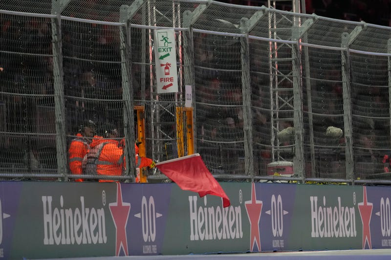 F1 track marshals wave a red flag during practice for the Formula 1 Heineken Silver Las Vegas Grand Prix 2025 at the Las Vegas Strip Circuit.