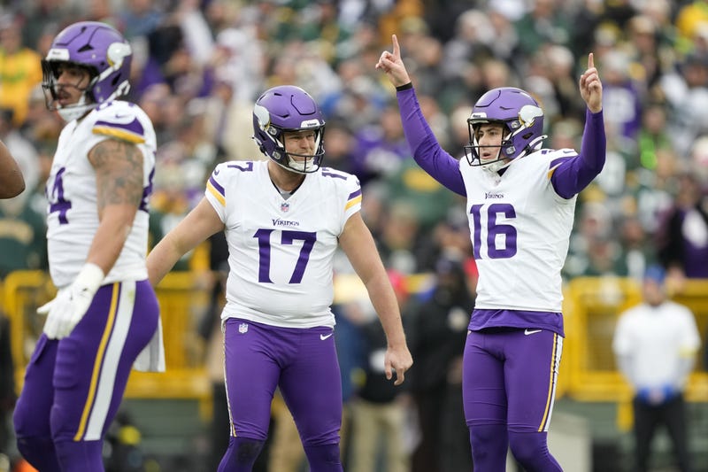 Minnesota Vikings place kicker Will Reichard (16) reacts with punter Ryan Wright (17) after kicking a field goal against the Green Bay Packers during the first half at Lambeau Field. 