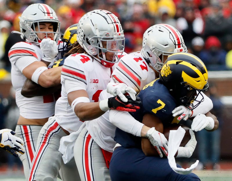 Ohio State Buckeyes safety Bryson Shaw (17) and Ohio State Buckeyes safety Ronnie Hickman (14) tackle Michigan Wolverines running back Donovan Edwards (7) during the third quarter in a NCAA College football game at Michigan Stadium at Ann Arbor, Mi on November 27, 2021.