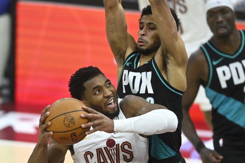 Dec 3, 2025; Cleveland, Ohio, USA; Cleveland Cavaliers guard Donovan Mitchell (45) drives against Portland Trail Blazers forward Toumani Camara (33) in the fourth quarter at Rocket Arena. 