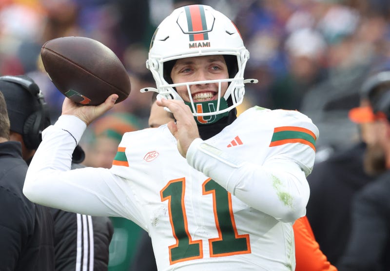 Nov 29, 2025; Pittsburgh, Pennsylvania, USA; Miami Hurricanes quarterback Carson Beck (11) throws on the sidelines to keep loose during the third quarter against the Pittsburgh Panthers at Acrisure Stadium. Mandatory Credit: Charles LeClaire-Imagn Images