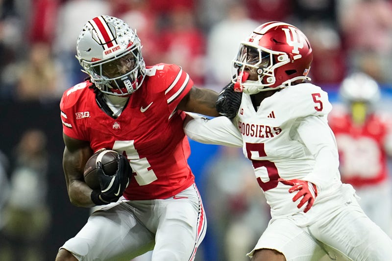 Ohio State Buckeyes wide receiver Jeremiah Smith (4) shakes off Indiana Hoosiers defensive back D'Angelo Ponds (5) during the Big Ten Conference championship game at Lucas Oil Stadium in Indianapolis on Dec. 6, 2025. Ohio State lost 13-10.