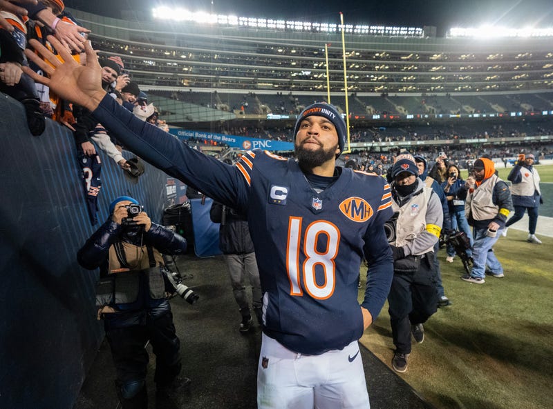 Bears quarterback Caleb Williams (18) high fives fans after their game Saturday, December 20, 2025 at Soldier Field