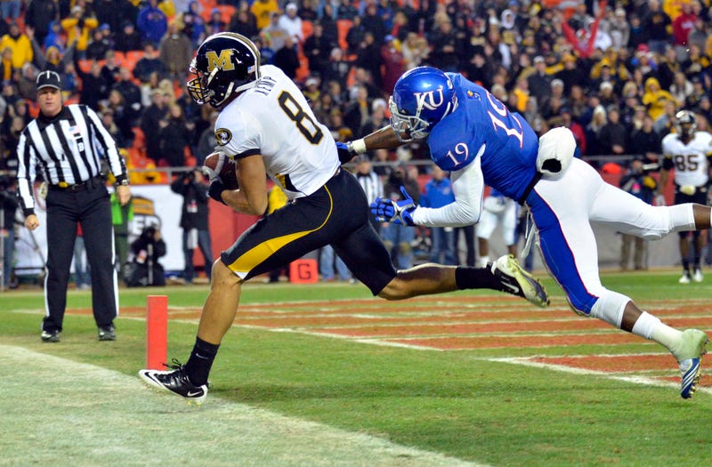Missouri Tigers wide receiver Wes Kemp (8) catches a pass for a touchdown as Kansas Jayhawks cornerback Isiah Barfield (19) defends in the fourth quarter at Arrowhead Stadium. Missouri won 24-10.