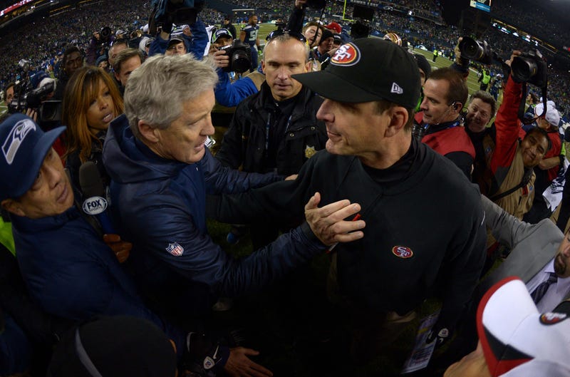 Seattle Seahawks coach Pete Carroll (right) and San Francisco 49ers coach Jim Harbaugh shake hands after the 2013 NFC Championship football game at CenturyLink Field.