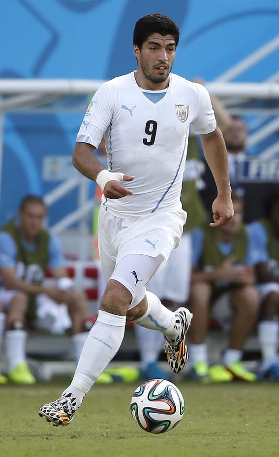 Uruguay forward Luis Suarez (9) carries the ball during the second half of their 1-0 win over Italy in a 2014 World Cup game at Estadio das Dunas.