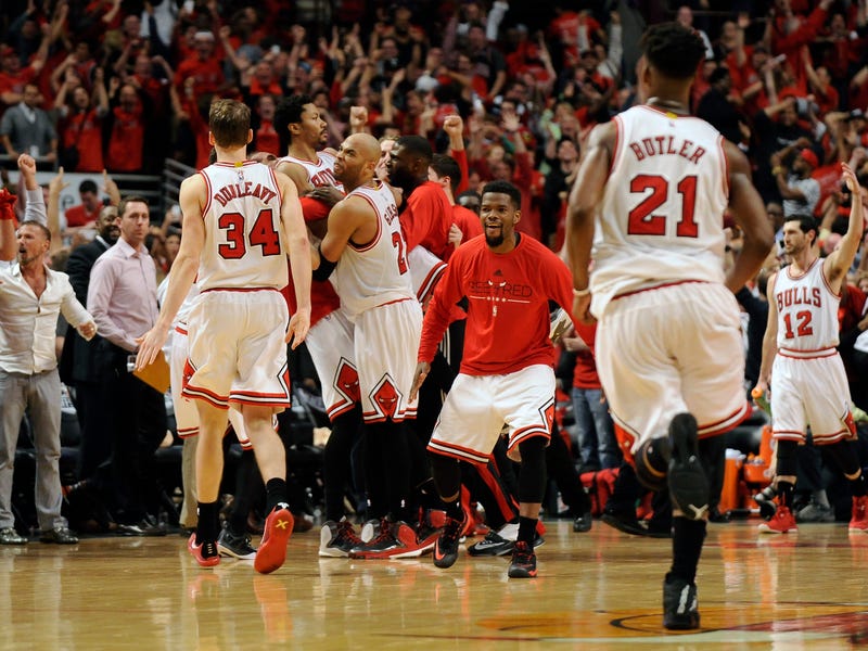 Chicago Bulls guard Derrick Rose (center) is lifted up by his teammates after hitting the game winning shot against the Cleveland Cavaliers during game three of the second round of the NBA Playoffs. at the United Center. The Chicago Bulls defeated the Cleveland Cavaliers 99-96.