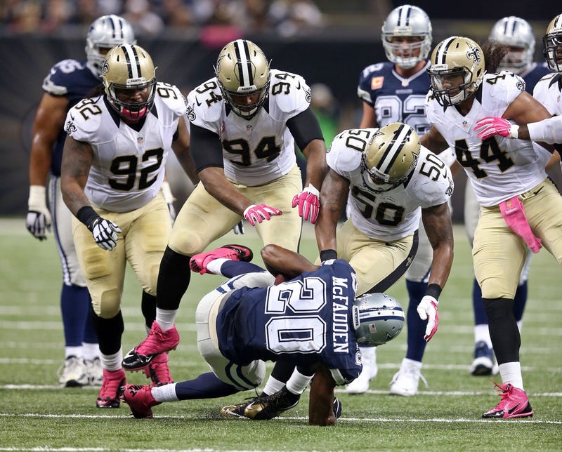 Saints LB Stephone Anthony (50) joins Cam Jordan (94) to tackle former Cowboys running back Darren McFadden.
